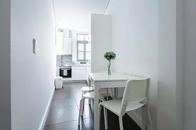 a white dining room with a white table and chairs at Nomad's Formosa - Apartments Porto in Porto