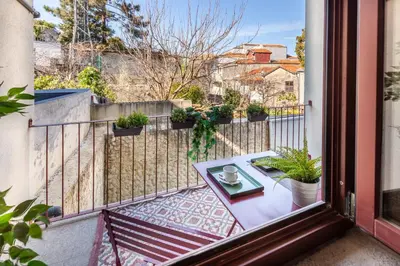a balcony with a table on a fence at Josephine Apartments in Porto