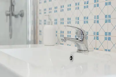 a bathroom sink with a faucet and a mirror at Ribeira Cozy Apartment in Porto