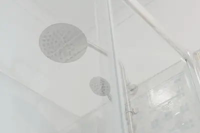 a shower with a shower head in a bathroom at Ribeira Cozy Apartment in Porto