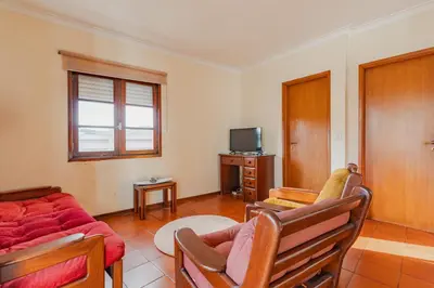 a living room with a couch and a tv at Ribeira Cozy Apartment in Porto
