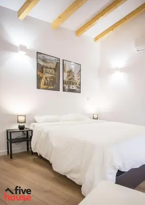 two beds in a room with white walls at Five House 14B in Porto