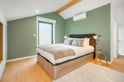 a bedroom with a large bed with green walls at WHome Riverside View Premium Apartment w/ AC & Terrace in Porto