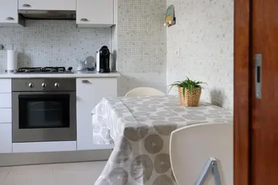 a kitchen with a table with a potted plant on it at Boavista Studio 99 & Garage in Porto