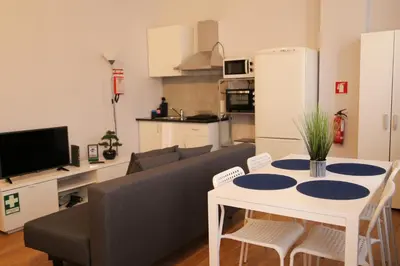 a living room with a table and a couch at Bonsai Apartment II in Porto