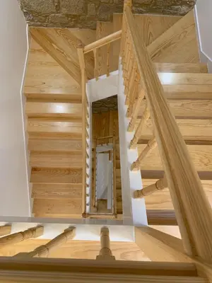 a wooden staircase in a house with wooden floors at Lost Inn Porto Hostel in Porto
