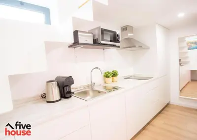 a white kitchen with a sink and a microwave at Five House 14A in Porto