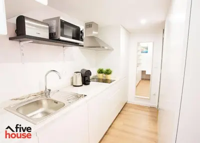 a white kitchen with a sink and a microwave at Five House 14A in Porto