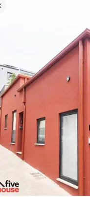 a red building with windows on the side of it at Five House 14A in Porto