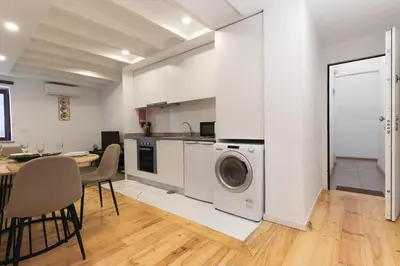 a kitchen and dining room with a table and a washing machine at Douro by your side with Pool in Vila Nova de Gaia