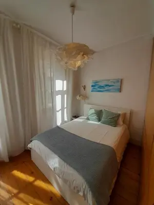 a bedroom with a bed and a large window at Comfortable Central 2 Bedrooms Apartments by Great&Cosy in Porto