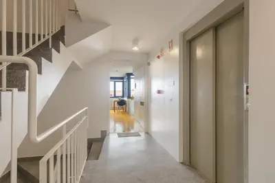 a hallway with white walls and a stair case at B Porto Casa da Música in Porto