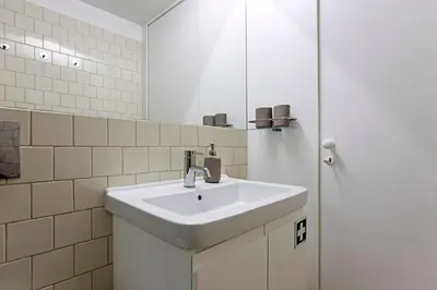 a bathroom with a white sink and a mirror at Lóios 1BR Flat Downtown by LovelyStay in Porto