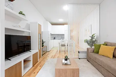 a living room with a couch and a table at Lóios 1BR Flat Downtown by LovelyStay in Porto