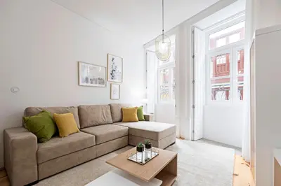 a living room with a couch and a table at Lóios 1BR Flat Downtown by LovelyStay in Porto