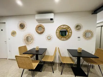 a dining room with two tables and chairs and mirrors at Lindo, funcional e charmoso espaço - Porto - APT H in Porto