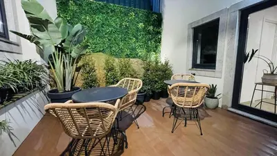 a patio with a table and chairs and plants at Lindo, funcional e charmoso espaço - Porto - APT H in Porto