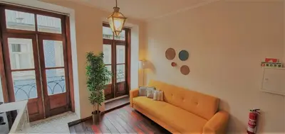 a living room with a couch and a window at Clérigos City Heart Flat in Porto