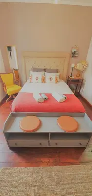 a bedroom with a large bed with a red blanket at Clérigos City Heart Flat in Porto