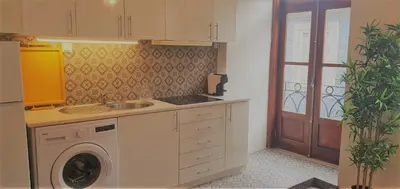 a kitchen with a washing machine and a sink at Clérigos City Heart Flat in Porto