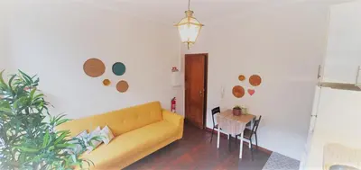 a living room with a yellow couch and a table at Clérigos City Heart Flat in Porto