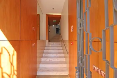 a long hallway with wooden walls and a staircase at FLH Sá da Bandeira Modern Apartment in Porto