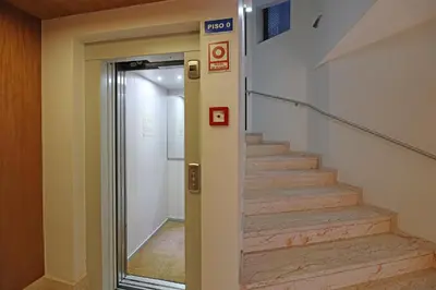 a elevator in a building with a stair case at FLH Sá da Bandeira Modern Apartment in Porto