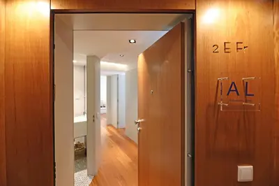 a hallway with a door with the number at FLH Sá da Bandeira Modern Apartment in Porto