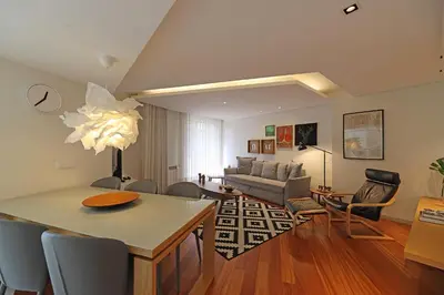 a living room with a couch and a table at FLH Sá da Bandeira Modern Apartment in Porto