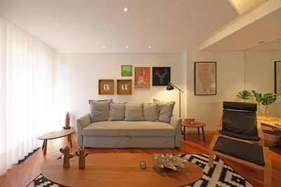 a living room with a couch and a table at FLH Sá da Bandeira Modern Apartment in Porto