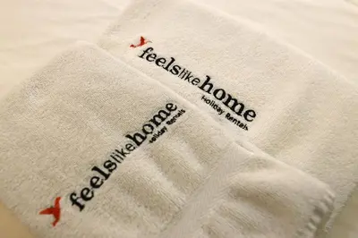a white towel with the words excellence wound on it at FLH Porto Ribeira Typical Studio in Porto
