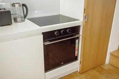 a microwave oven in a kitchen with a counter at OPORTO GUEST Lotte House in Porto