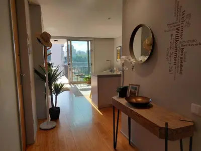 a living room with a table and a mirror at Balconies of Cedofeita & Garage in Porto