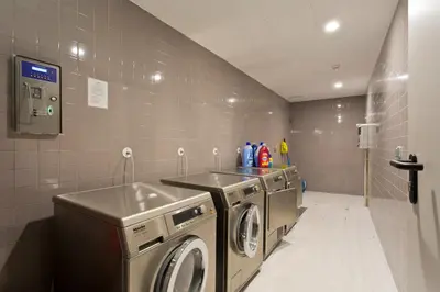 a laundry room with two washing machines and a sink at Balconies of Cedofeita & Garage in Porto