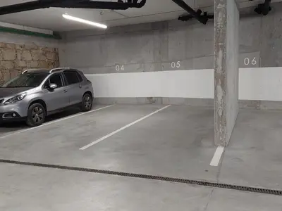 a parking garage with a car parked in it at Balconies of Cedofeita & Garage in Porto
