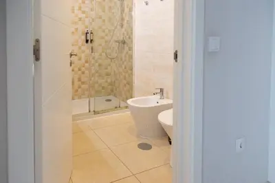 a bathroom with a shower and a toilet and a sink at Marquês Deluxe Apartments 3 & 4 in Porto