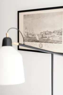 a picture hanging on a wall next to a lamp at VIVA Whilom Secret with garage in Porto