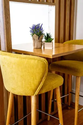 a dining room table with two yellow chairs and a wooden table at Mouzinho 129 - Medronheiro & Oliveira in Porto