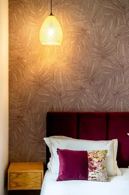 a bedroom with a bed with a purple pillow and a lamp at Mouzinho 129 - Medronheiro & Oliveira in Porto