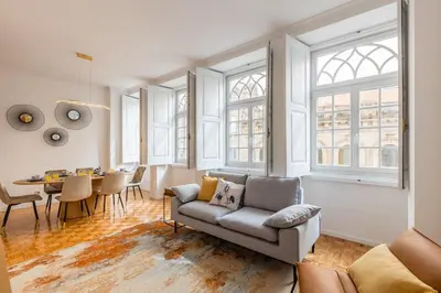 a living room with a couch and a table at São Bento Deluxe 42 with Balcony in Porto