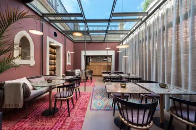 two beds in a hotel room with windows at Jardins do Porto - by Unlock Hotels in Porto