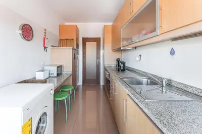 a kitchen with a sink and a dishwasher at GuestReady - Warwick avenue in Lapa in Porto