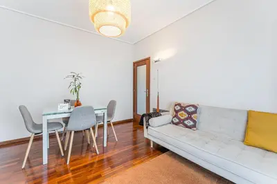 a living room with a couch and a table at GuestReady - Warwick avenue in Lapa in Porto
