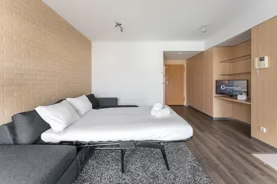 a living room with a bed and a couch at GuestReady - Antas Studio in Porto