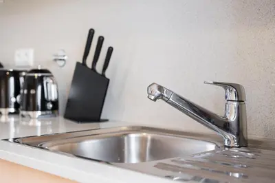a kitchen sink with a faucet on a counter at GuestReady - Antas Studio in Porto