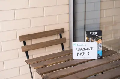 a sign sitting on a bench next to a window at GuestReady - Antas Studio in Porto