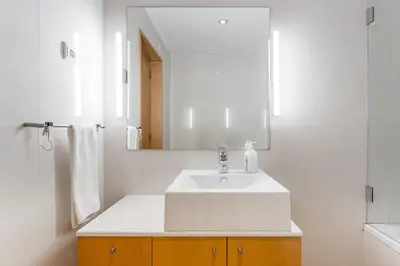 a bathroom with a white sink and a mirror at GuestReady - Antas Studio in Porto