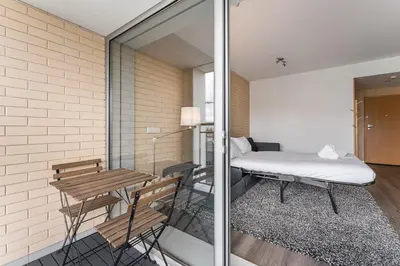 a room with a bed and a table and chairs at GuestReady - Antas Studio in Porto
