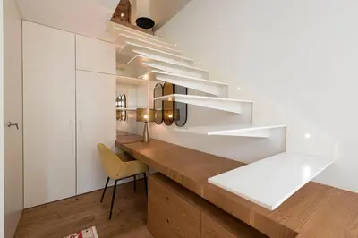 a kitchen with white cabinets and a desk with a chair at Classy & Stylish Porto Duplex in Porto