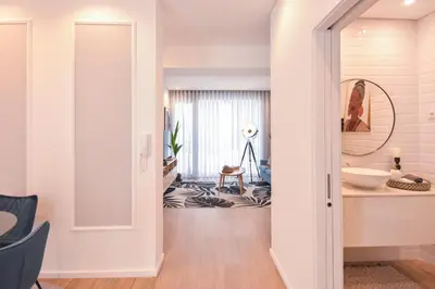a hallway with a door leading into a room with a bathroom at Oporto lovely house deluxe in Porto